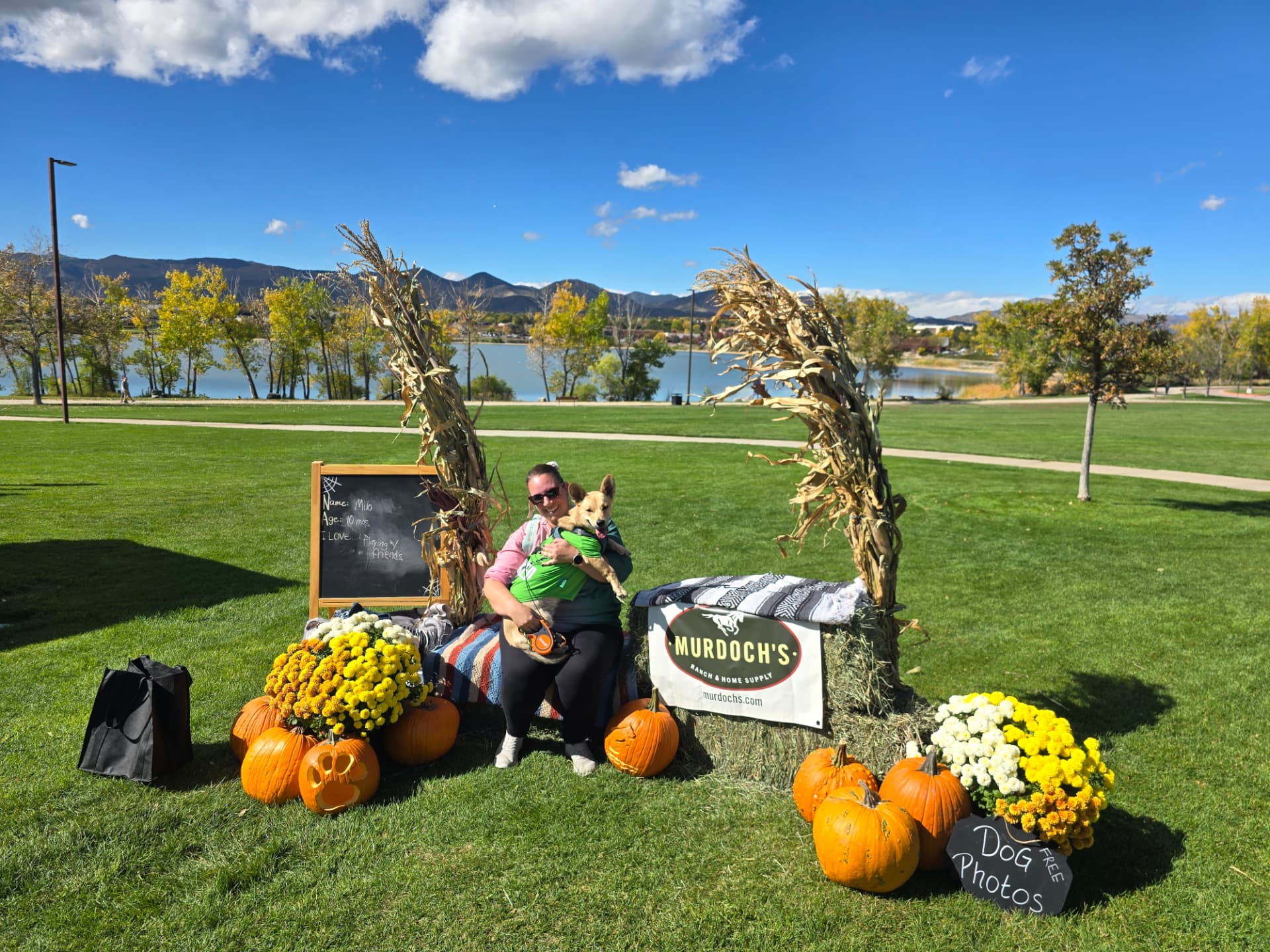 Caitlin with a dog at a fall pumpkin photo event by the lake