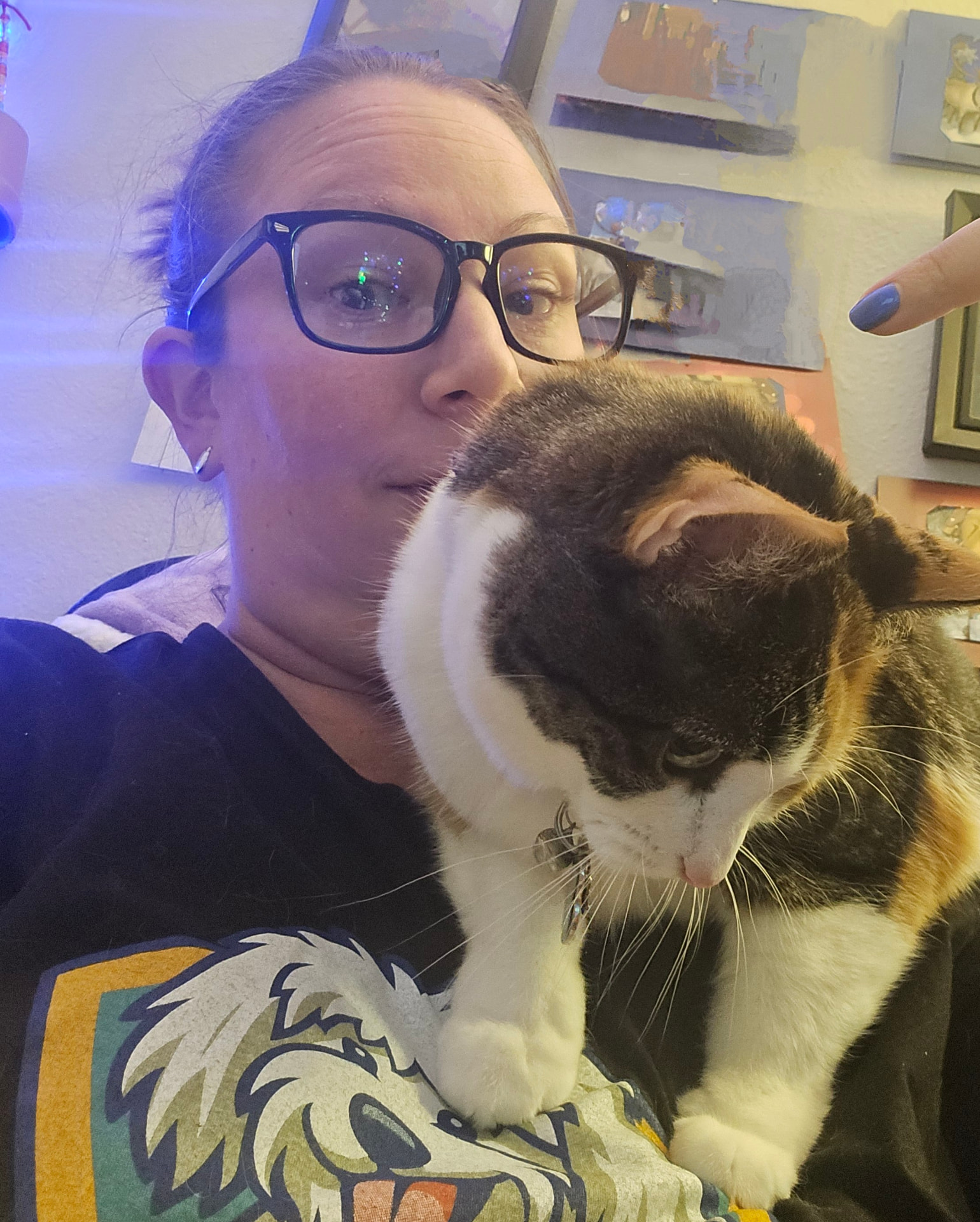 Caitlin with a fluffy calico cat on her shoulder