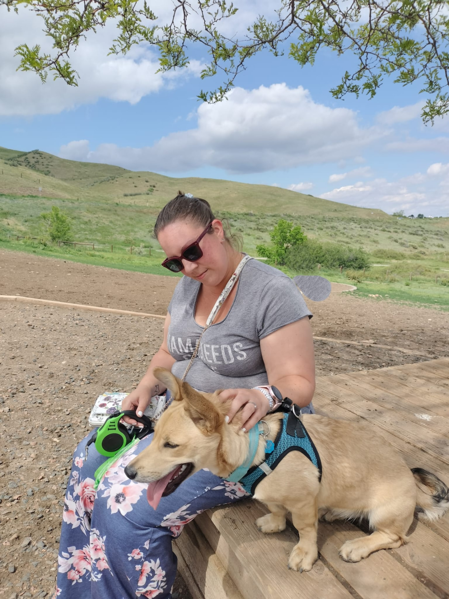Caitlin with a happy dog on a hiking trail
